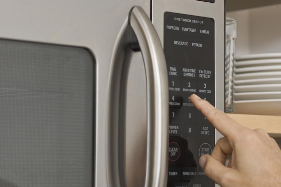 person using microwave